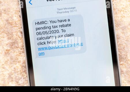 Message d'escroquerie affiché sur un iphone qui prétend être de HMRC avec une remise de taxe en attente. Banque D'Images