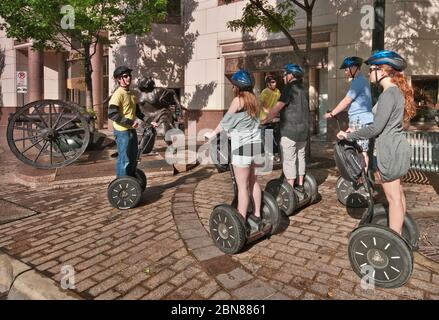 Touristes sur Segway PT deux transporteurs personnels à roues à la sculpture d'Angelina Eberly tirant un canon, Congress Avenue, Downtown Austin, Texas, États-Unis Banque D'Images