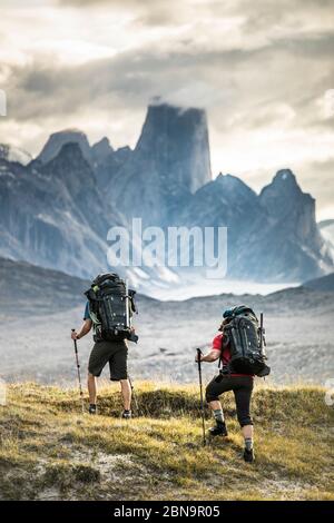 Deux grimpeurs montent en direction du mont Asgard dans le col d'Akshayak Banque D'Images