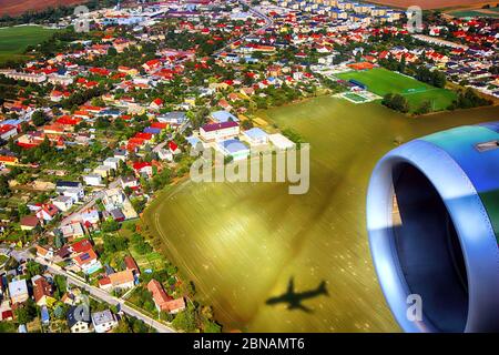 Vue sur le village, champ agricole depuis un avion près de Bratislava, Slovaquie. Ombre d'un avion sur le terrain. Banque D'Images