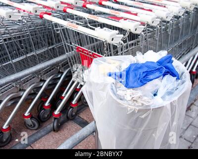 Cremona, Lombardie, Italie - 13 mai 2020 - poubelle et déchets à proximité des chariots à l'extérieur du supermarché, pas de gens Banque D'Images