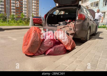 jeu de roues. Les roues sont emballées dans des sacs et se trouvent près de la voiture. Banque D'Images
