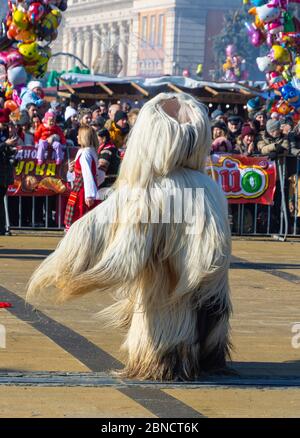 Mummer exécute des rituels avec des costumes, destinés à effrayer les mauvais esprits pendant le festival international de jeux de mascarade Surva. Masques Kuker. Banque D'Images