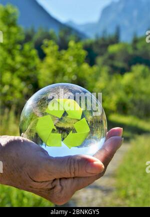 main avec symbole de reyeclissement de sphère de verre Banque D'Images