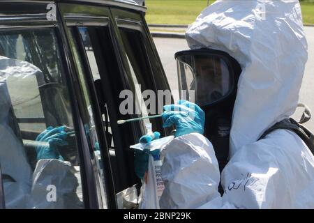 Les soldats de la Garde nationale de Virginie prennent un échantillon d'écouvillonnage d'un patient dans un site de test en voiture du coronavirus COVID-19 au Eastern Shore Community College le 8 mai 2020 à Melfa, en Virginie. Banque D'Images