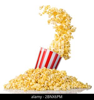Pop-corn volant dans un seau à rayures et pop-corn dispersé isolé sur du blanc Banque D'Images