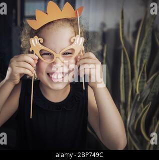 Portrait de petite fille drôle avec des accessoires en papier Banque D'Images