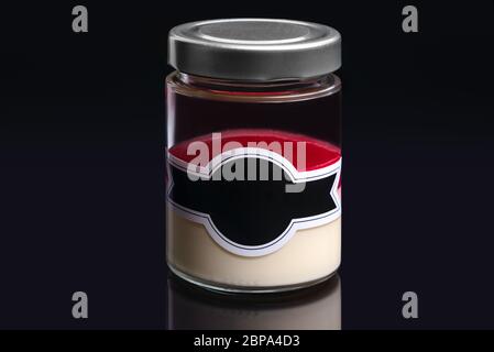 Dessert lactée à la crème et gelée fruitée dans un pot isolé sur fond noir. Banque D'Images