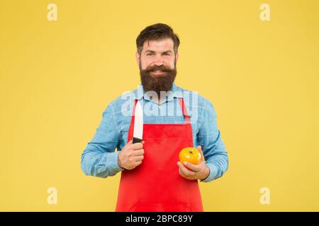 Liste ultime des techniques de coupe que chaque chef devrait savoir. Le chef prépare le repas. Homme barbu préparer la tomate. Homme mature tient le couteau et le légume. Recette de salade fraîche. Coupe sûre. Couper des légumes. Banque D'Images