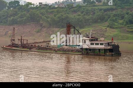 Huangqikou, Chongqing, Chine - 8 mai 2010 : fleuve Yangtze. Opérations de dragage en cours de 2 bateaux. Petit réservoir de pompage derrière la barge rempli de tas Banque D'Images