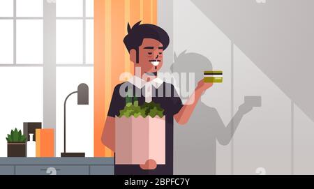 homme indien tenant sac de shopping plein de légumes frais et carte de crédit moderne salon intérieur horizontal portrait illustration vectorielle Illustration de Vecteur