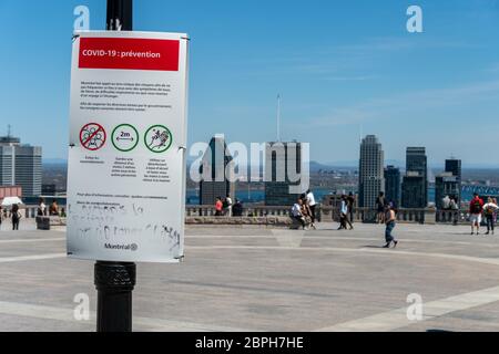 Montréal, CA - 18 mai 2020 : affiche montrant les lignes directrices françaises Covid-19 et les gratte-ciel de Montréal au loin. Banque D'Images