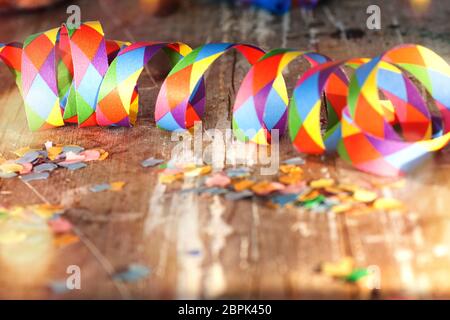 Confettis et banderoles colorés avec bokeh sur le vieux bois de sorbette pour un terrain de bachground de carnaval Banque D'Images