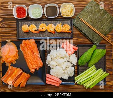 Fruits de mer et ingrédients pour faire des sushis sur fond de bois Banque D'Images