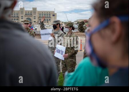 Manhattan, Kansas, États-Unis. 19 mai 2020. De gauche à droite, DAVID SALINAS et TAYLOR STEVENS, tiennent des panneaux pour remercier les travailleurs de la santé locaux en dehors de l'Ascension via Christi Hospital, mardi. La 190ème Escadre de ravitaillement en vol de la garde nationale aérienne du Kansas a survolé Manhattan, Kansas, à 13:13 pour saluer les travailleurs de la santé, les premiers intervenants et les autres travailleurs de première ligne dans la lutte contre le COVID-19. L'opération Kansas Strong a débuté à Emporia, au Kansas, et a survolé Manhattan, Lawrence et Topeka, au Kansas. Crédit: Luke Townsend/ZUMA Wire/Alay Live News Banque D'Images