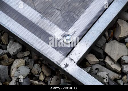 Fixations en polycarbonate avec une armature métallique vis. Les émissions de l'installation, l'installation de serres en polycarbonate. Les émissions pour la maison jardin. Banque D'Images