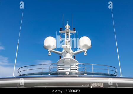 Antennes de communication avec l'équipement de navigation, le radar sur le pont supérieur du navire de croisière de luxe blanc. Il y a un pavillon thaï avec ciel bleu clair je Banque D'Images