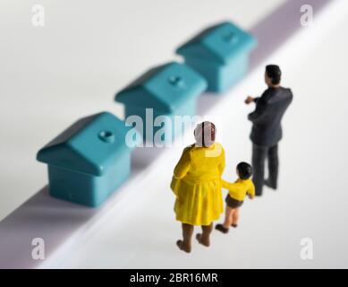 Figurine miniature famille achetant une maison, maison, concept Banque D'Images