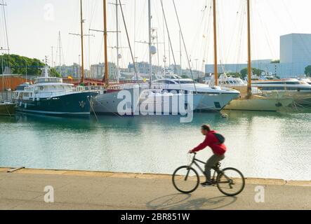 Man riding bicycle à Port Vell de Barcelone. motion blur Banque D'Images