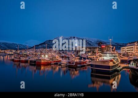 Tromso, Norvège - Décembre 2018 : Bateaux dans port et port dans le détroit d'Tromsoysundet à Tromso en hiver la nuit Banque D'Images