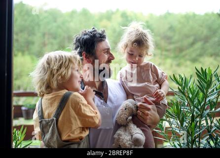 Père médecin finalement à la maison de rencontrer ses enfants, fin du coronavirus. Banque D'Images