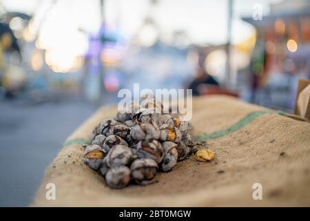 Marrons torréfiés savoureux vendus sur le marché de Faro, Portugal Banque D'Images