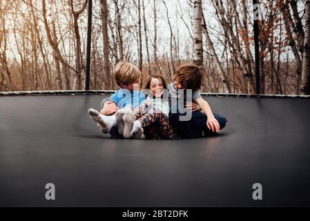 Trois enfants jouant sur un trampoline, USA Banque D'Images