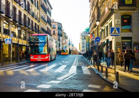 Bus touristique dans la Calle de Toledo Madrid Espagne dans l'après-midi près d'un passage à Zèbre. Banque D'Images