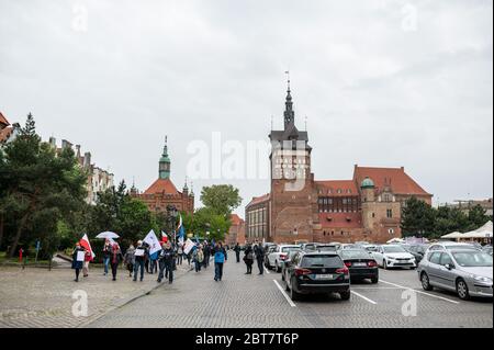 Des manifestants marchant avec des drapeaux le long de la rue Dluga pendant la manifestation.le Komitet Obrony Demokracji (Comité de défense de la démocratie) a exprimé son opposition à des violations de la loi et des normes démocratiques en Pologne où la pandémie a été utilisée pour restreindre illégalement les libertés et libertés civiles. Banque D'Images