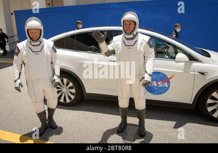 Cape Canaveral, États-Unis d'Amérique. 23 mai 2020. Les astronautes de la NASA Douglas Hurley, à gauche, et Robert Behnken, qui portent des espaces SpaceX, se mettent à la vague en quittant le bâtiment Neil Armstrong Operations and Checkout Building pour le complexe de lancement 39A lors d'une répétition de la tenue vestimentaire avant le lancement de la mission Demo-2 au Kennedy Space Center le 23 mai 2020, Cape Canaveral, en Floride. La mission SpaceX Demo-2 de la NASA est le premier lancement commercial qui transporte des astronautes à la Station spatiale internationale. Crédit : Bill Ingalls/NASA/Alay Live News Banque D'Images