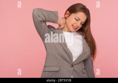 Portrait de la jeune femme surtravaillée stressée en costume d'affaires touchant le cou douloureux, souffrant de douleurs musculaires, de blessures aux épaules, se sentant malsain Banque D'Images