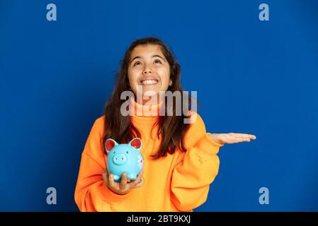 Adorable jeune fille de prètine avec jersey jaune sur fond bleu Banque D'Images