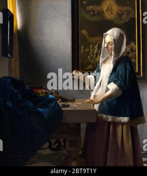 Johannes Vermeer (Néerlandais, 1632 - 1675), Femme tenant un équilibre, ch. 1664, huile sur toile, Widener Collection 1942.9.97 Banque D'Images