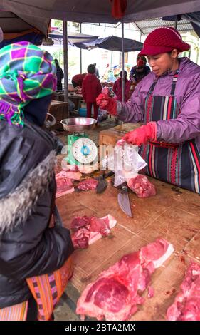 Bac Ha, Vietnam, 7 janvier 2020 - Boucher à bac Ha Market saling la viande crue sur sa table noire en bois Banque D'Images