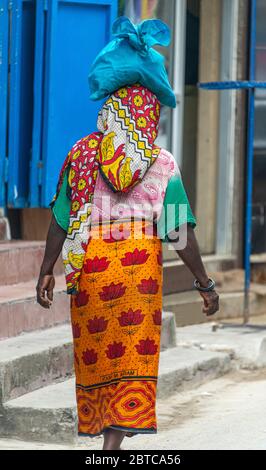 Femme portant un sac sur la tête portant des vêtements traditionnels colorés Banque D'Images