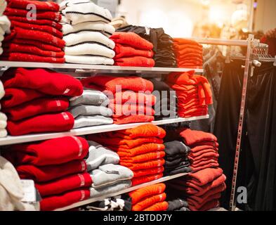 Vendre dans le magasin des sueurs et des vestes chauds. Vêtements tendance et élégants, une pile de vestes naturelles multicolores, pull-over Banque D'Images