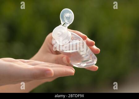 Une vraie jeune femme nettoie ses mains avec du gel hydroalcoolique comme méthode de prévention pour éviter de répandre COVID-19 à d'autres personnes à Madrid. Banque D'Images