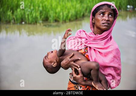 Rohingya réfugié au Bangladesh. Une mère qui wither son enfant malade. La plupart des enfants souffrent de fièvre élevée, de problèmes d'épiderme et de dysenterie. Banque D'Images