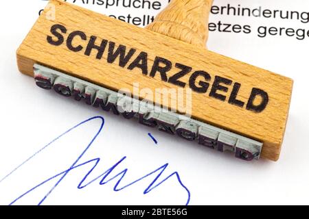 Timbre en bois sur un document lettrage Schwarzgeld, argent noir Banque D'Images