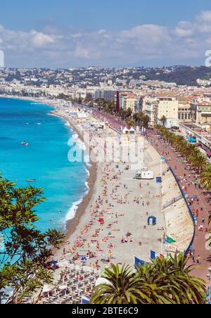 Nice, Côte d'Azur, France. Baigneurs sur la plage en face de la Promenade des Anglais. Vue depuis le Parc de la Colline du Château. Banque D'Images