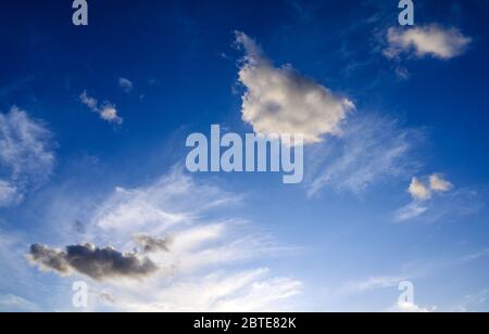 Des nuages blancs et sombres spectaculaires sur un fond bleu profond. Illustre la nature, l'environnement, le temps, le ciel et la beauté. De beaux nuages. Banque D'Images