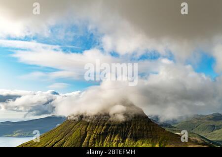 Foggy Mountain peaks et les nuages couvrant la mer et les montagnes. Panoramical view à partir de la célèbre place - Sornfelli sur Streymoy island, îles Féroé, Danemark. Photographie de paysage Banque D'Images