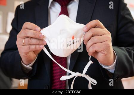 Hambourg, Allemagne. 25 mai 2020. Le sénateur de l'école et de la formation professionnelle de Hambourg, le sénateur de la SPD (TEF), porte la bouche et le nez avec le logo de Hambourg lors d'une séance photo à l'école primaire de Wielandstraße. Après trois mois de vacances et des cours en ligne, tous les élèves de Hambourg doivent revoir leurs enseignants cette semaine. Le lundi, Rabe a accepté les premiers masques d'un don de 50,000 masques de la société de vente par correspondance en ligne vous concernant à l'école primaire du district d'Eilbek. Credit: Christian Charisius/dpa/Alay Live News Banque D'Images