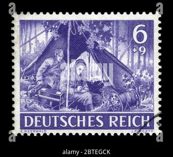 Historique allemand stamp : communicateur militaire, reçoit et transmet l'ordre à la radio. Le signal corps de la Wehrmacht, Memorial Day 1943 Banque D'Images