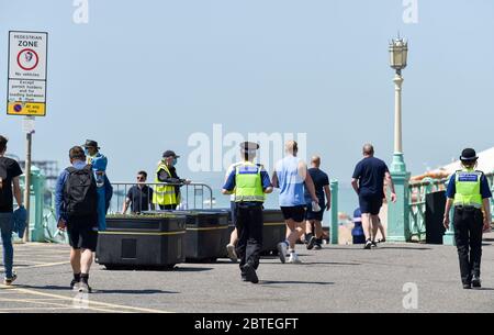 Brighton UK 25 mai 2020 - les visiteurs apprécient les vacances en banque soleil chaud sur la plage de Brighton aujourd'hui que les températures devraient atteindre les 20's élevés dans le sud-est de l'Angleterre pendant la crise pandémique du coronavirus COVID-19 . Crédit : Simon Dack / Alamy Live News Banque D'Images