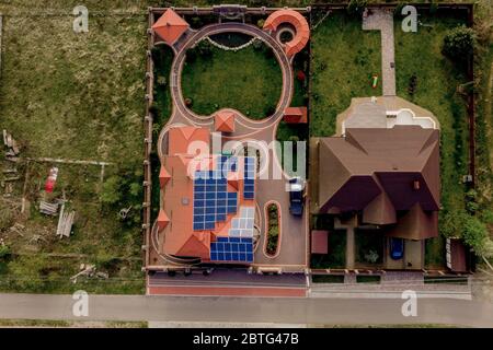 Vue aérienne sur le nouveau cottage résidentiel moderne avec panneaux bleus. Concept de production d'énergie verte écologique renouvelable Banque D'Images