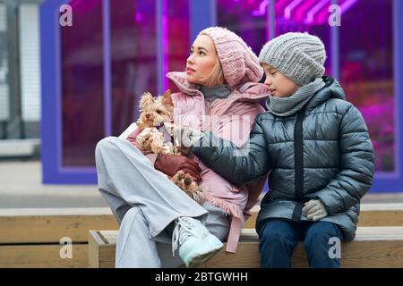 Bonne famille à pied avec leur drôle de terrier. Petit chien avec une maman et un fils hipster élégants passent du temps à jouer à l'extérieur et à s'amuser. Portrait de style de vie. L'amour entre animal de compagnie et propriétaire. Heure de la famille Banque D'Images