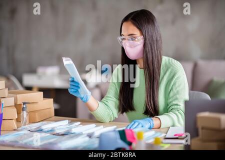 Photo de la chinoise occupée dame famille affaires organisation emballage visage grippe masques médicaux propagation globale vérifier qualité valeur réputation préparer Banque D'Images