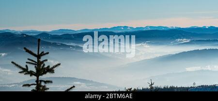 Vue sur les montagnes de Nizke Tatry avec les plus proches Beskid Zywiecki, Oravska Magura et Velky Choc en Slovaquie depuis la colline de Magurka Wislaska dans le moun de Beskid Slaski Banque D'Images