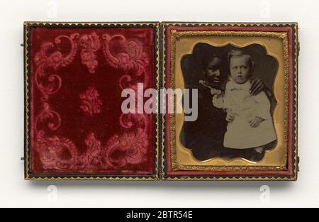 Tintype d'une jeune femme avec un enfant. Cette photo de 1/6 plaques en forme de tinion représente une jeune femme avec un bébé. La jeune femme est assise, portant une robe de couleur foncée et un col en dentelle de couleur claire. Elle tient le bébé sur ses genoux. Le bébé porte une longue robe de couleur claire et a des joues roses teintées. Banque D'Images